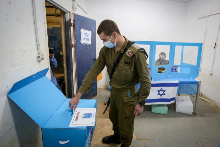 חייל הנדסה קרבית משלשל את מעטפת הבחירות לקלפי