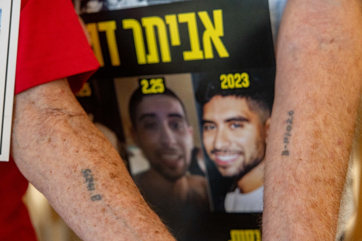 טומי ונפתלי על רקע תמונות החטופים